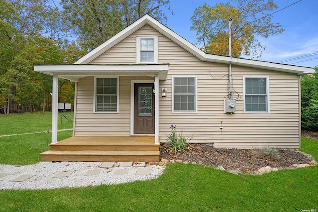 bungalow-style home with a porch and a front yard