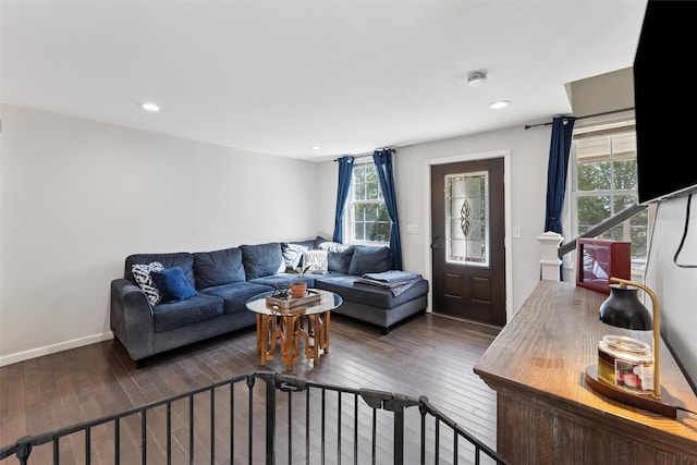 living room with recessed lighting, baseboards, and wood-type flooring