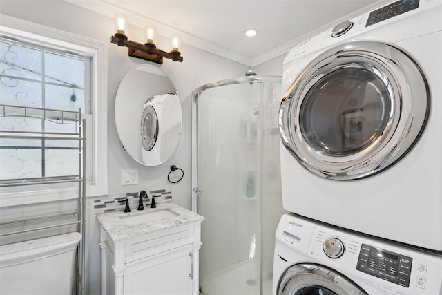 laundry room with stacked washer and dryer, laundry area, plenty of natural light, and a sink