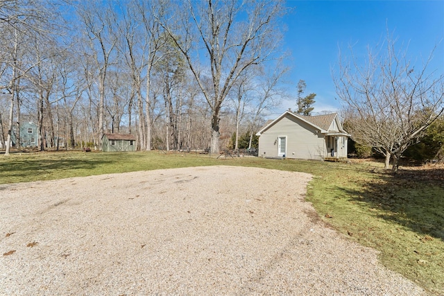 view of yard with an outbuilding and a shed