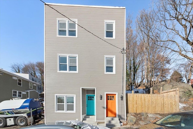 view of front of house with entry steps and fence