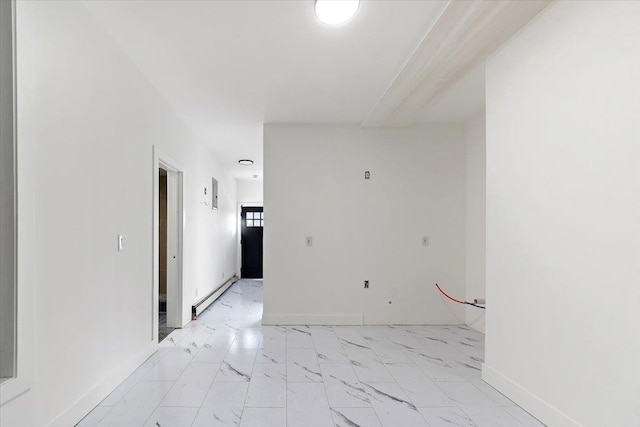 unfurnished room featuring a baseboard heating unit, baseboards, and marble finish floor