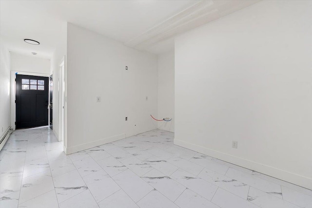 spare room featuring baseboards and marble finish floor