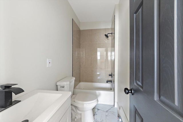 bathroom featuring vanity, toilet, marble finish floor, and bathing tub / shower combination