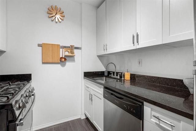 333 Bronx River Rd Unit 123, Yonkers, NY 10704 - kitchen with stainless steel appliances, a sink, dark stone countertops, white cabinetry, and dark wood-style floors