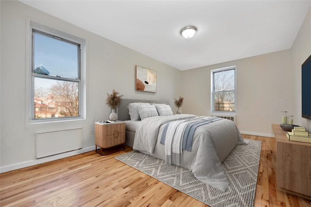 bedroom featuring baseboards and wood finished floors