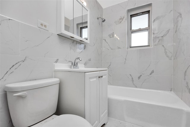 bathroom featuring toilet, tile walls, shower / washtub combination, and vanity