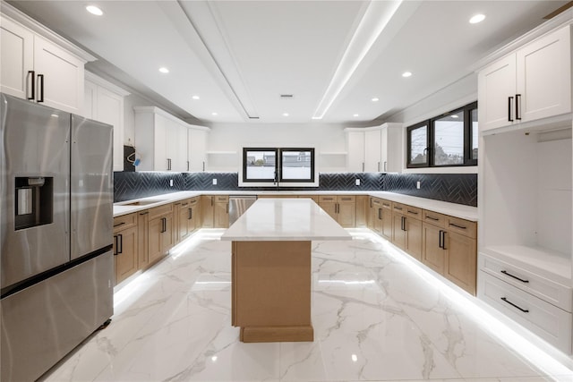 kitchen with marble finish floor, open shelves, a kitchen island, stainless steel appliances, and decorative backsplash