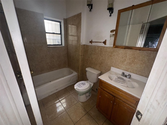 full bath with vanity, tub / shower combination, tile walls, toilet, and tile patterned floors