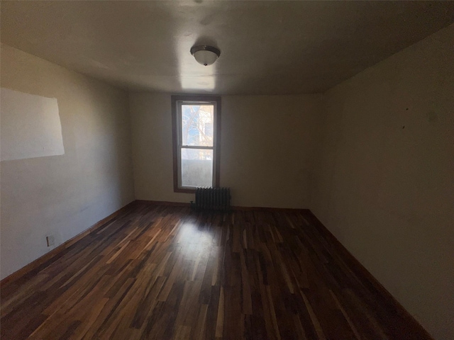 unfurnished room with dark wood-style floors