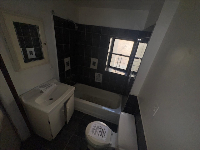 bathroom with tile patterned floors, toilet, shower / bathing tub combination, and a sink