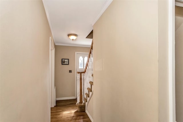 hallway with crown molding, stairway, wood finished floors, and baseboards