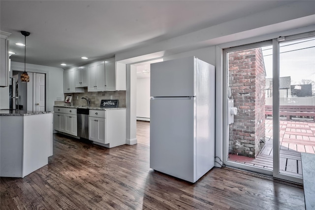 kitchen with stone counters, dishwasher, freestanding refrigerator, and dark wood-type flooring