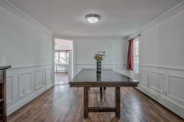 dining area with dark wood-type flooring, crown molding, and a wealth of natural light