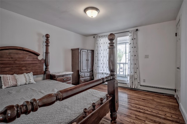 bedroom featuring a baseboard radiator and wood finished floors