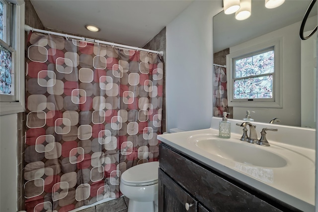 bathroom with vanity, a shower with shower curtain, and toilet