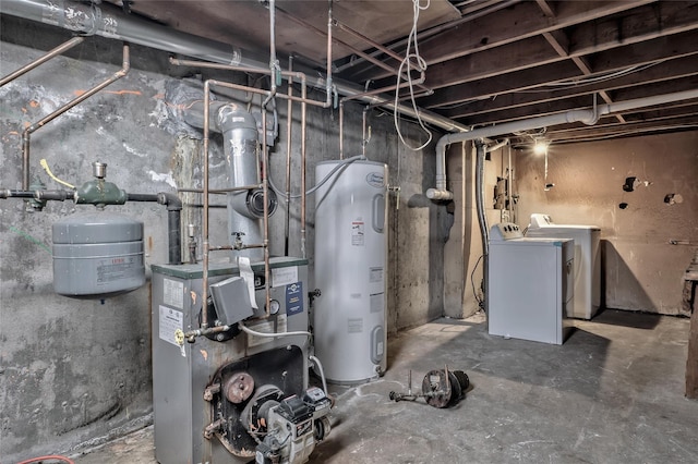 unfinished below grade area featuring washer and dryer, electric water heater, and a heating unit