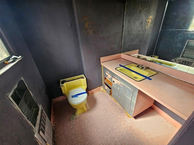 bathroom featuring toilet, vanity, and tile patterned flooring