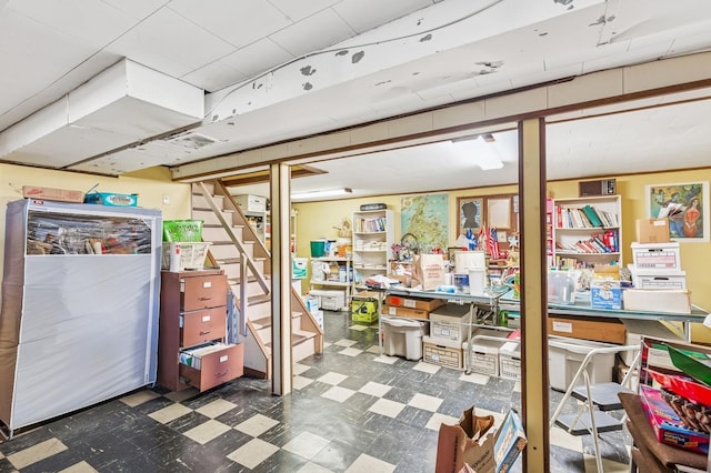 finished basement featuring tile patterned floors and stairs