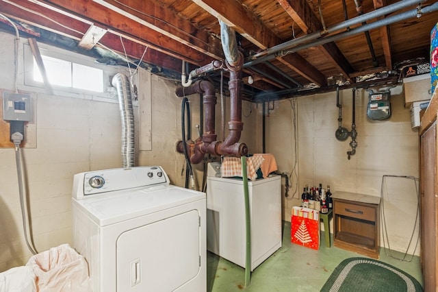 clothes washing area featuring laundry area and washer and clothes dryer