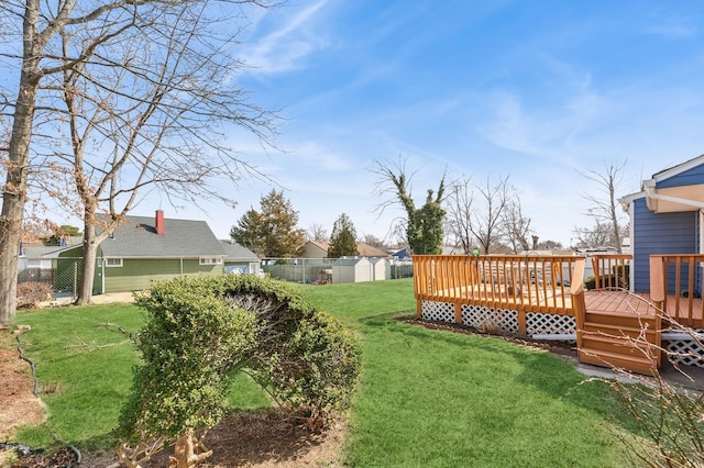 view of yard with a deck and fence