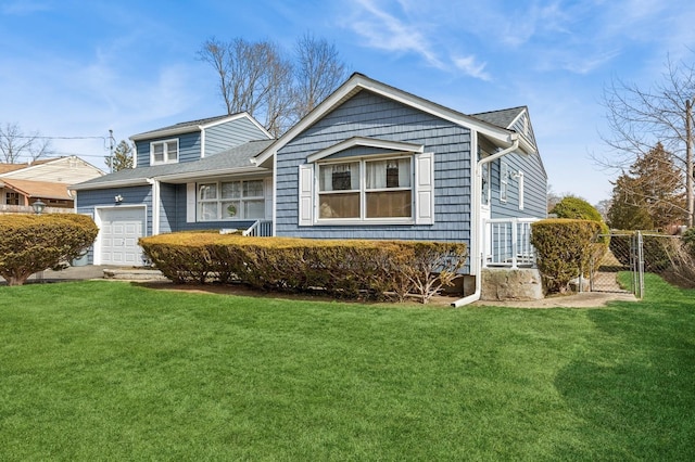 view of front facade with a gate, a garage, a front lawn, and fence