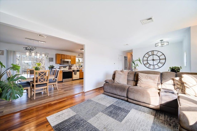 living room featuring light wood finished floors and visible vents