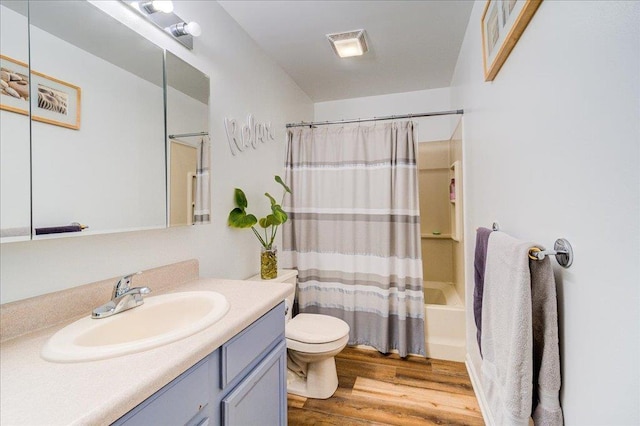 bathroom with vanity, shower / tub combo, toilet, and wood finished floors