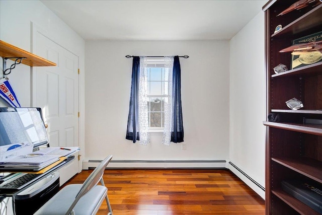 office with wood finished floors and baseboard heating