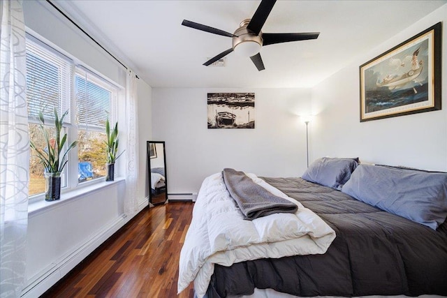 bedroom featuring ceiling fan, baseboards, baseboard heating, and wood finished floors