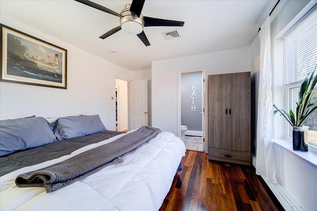 bedroom featuring visible vents, connected bathroom, ceiling fan, and wood finished floors