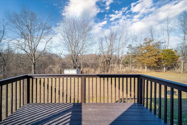 deck with an outbuilding, a storage unit, and a lawn