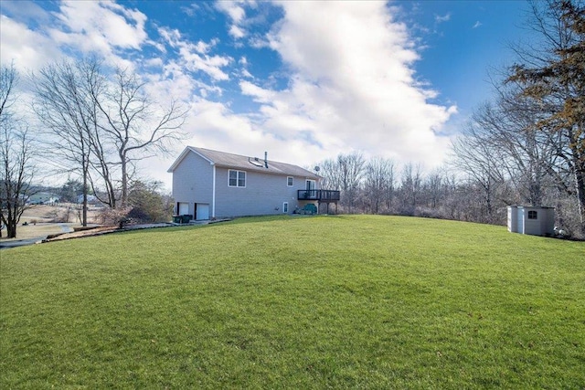 view of yard featuring an attached garage and an outdoor structure