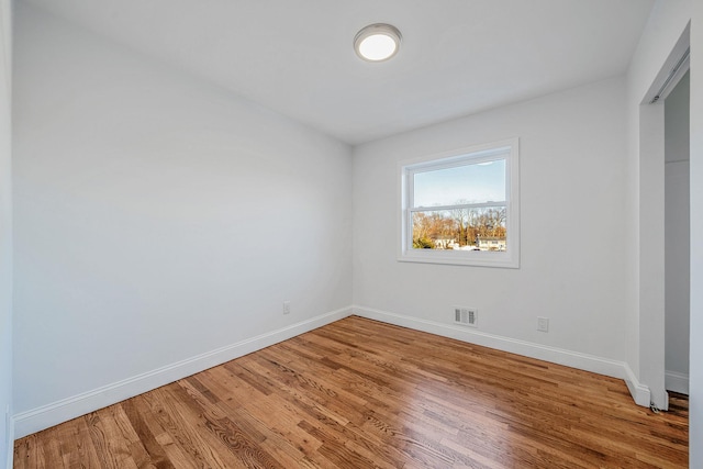 unfurnished bedroom featuring visible vents, baseboards, and light wood finished floors