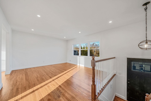 interior space featuring recessed lighting, wood finished floors, and baseboards