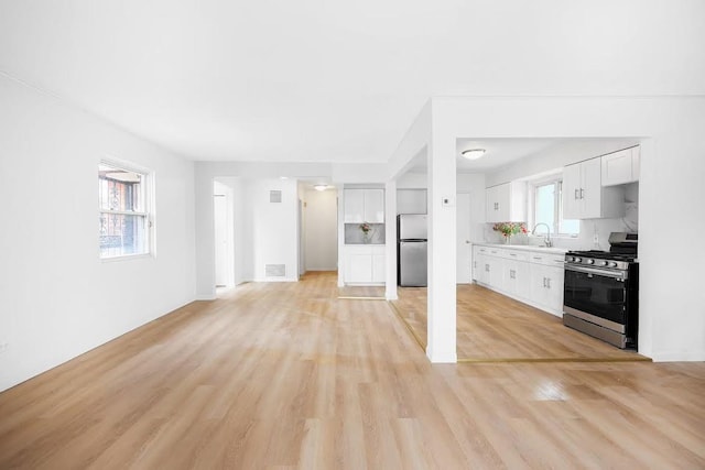 28-34 Corporal Kennedy St, Flushing, NY 11360 - unfurnished living room with light wood-style flooring