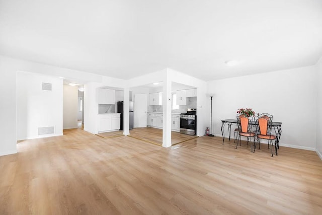 28-34 Corporal Kennedy St, Flushing, NY 11360 - living area with light wood-style flooring and baseboards