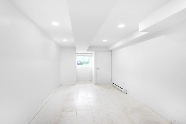 28-34 Corporal Kennedy St, Flushing, NY 11360 - empty room featuring a baseboard heating unit, recessed lighting, and baseboards