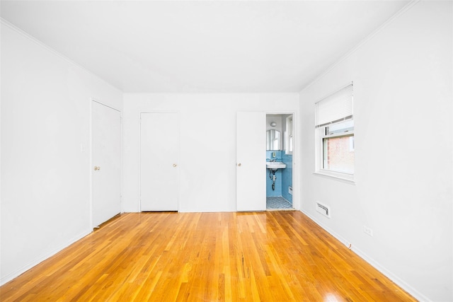 28-34 Corporal Kennedy St, Flushing, NY 11360 - unfurnished room featuring light wood-style floors and crown molding