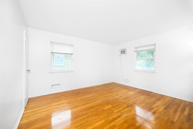 28-34 Corporal Kennedy St, Flushing, NY 11360 - spare room featuring light wood-type flooring and a wall mounted AC