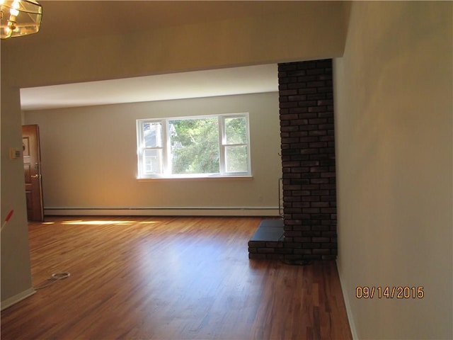 unfurnished living room with a baseboard radiator and wood finished floors