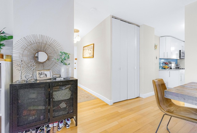 interior space with light wood-style flooring and baseboards