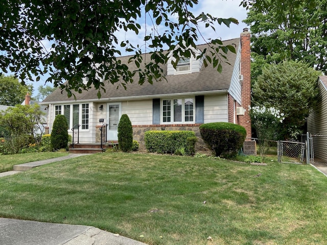 cape cod house featuring a gate, fence, a front yard, a shingled roof, and a chimney