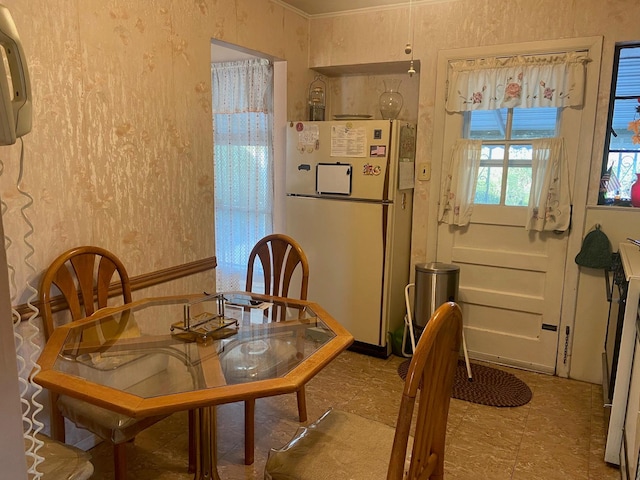 dining room with wallpapered walls