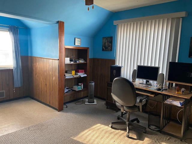 home office featuring a wainscoted wall, wooden walls, and vaulted ceiling