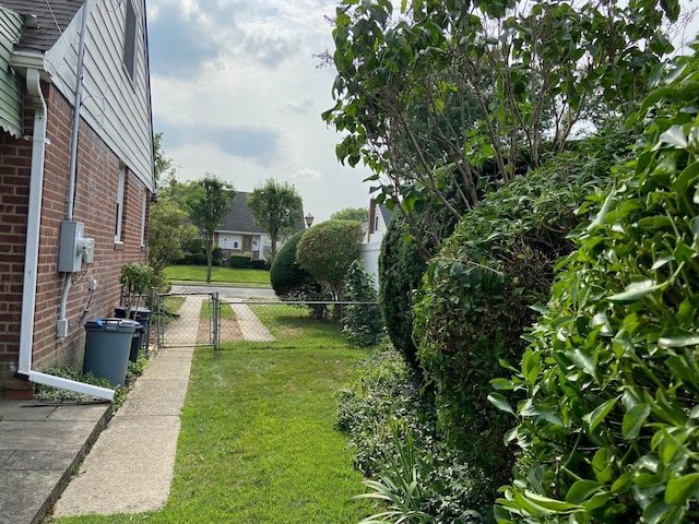 view of yard with fence and a gate