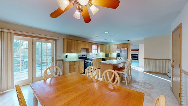 dining area featuring light tile patterned floors, baseboard heating, recessed lighting, wainscoting, and a ceiling fan