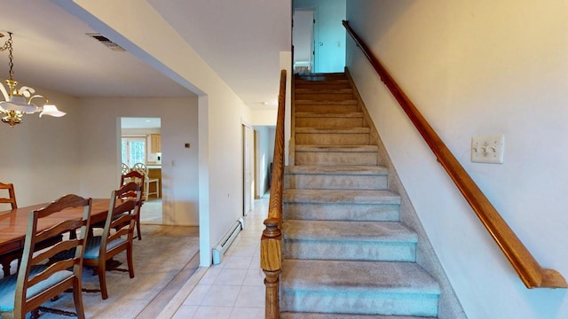 stairs with tile patterned flooring, visible vents, baseboard heating, and a chandelier