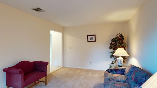 sitting room featuring visible vents and carpet flooring