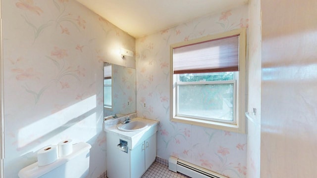 half bathroom with wallpapered walls, toilet, vanity, and a baseboard radiator